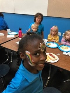Face Painted Students Eat Dinner