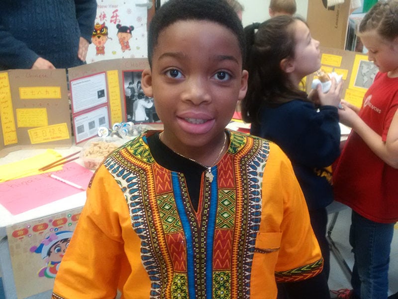 Student in Traditional African Clothing Discusses What He Learned